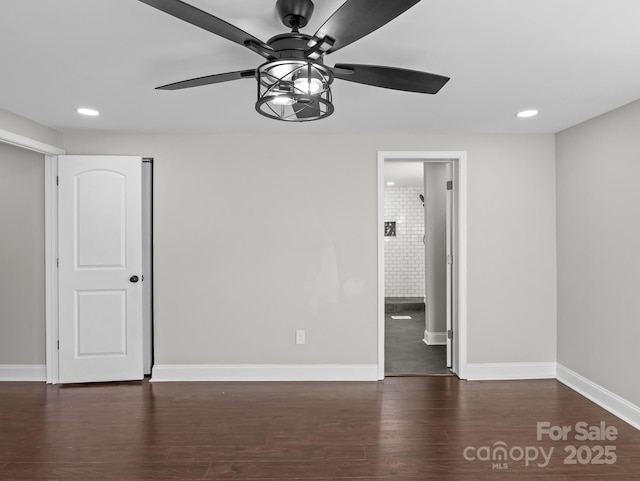 unfurnished room featuring ceiling fan and dark wood-type flooring