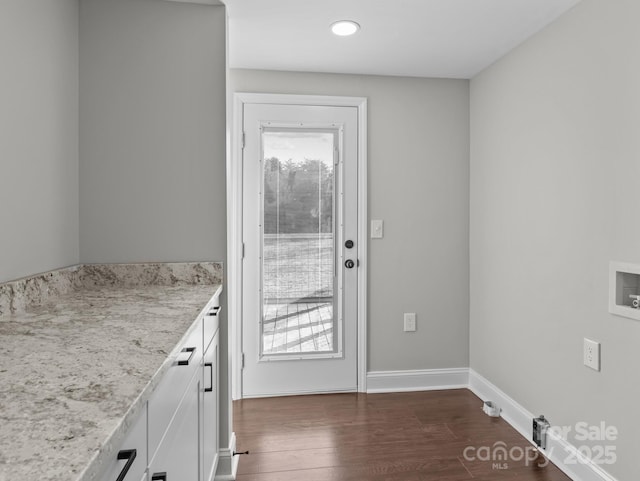 doorway featuring plenty of natural light and dark hardwood / wood-style floors