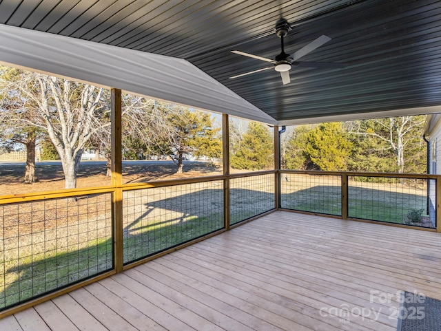 unfurnished sunroom with vaulted ceiling and ceiling fan