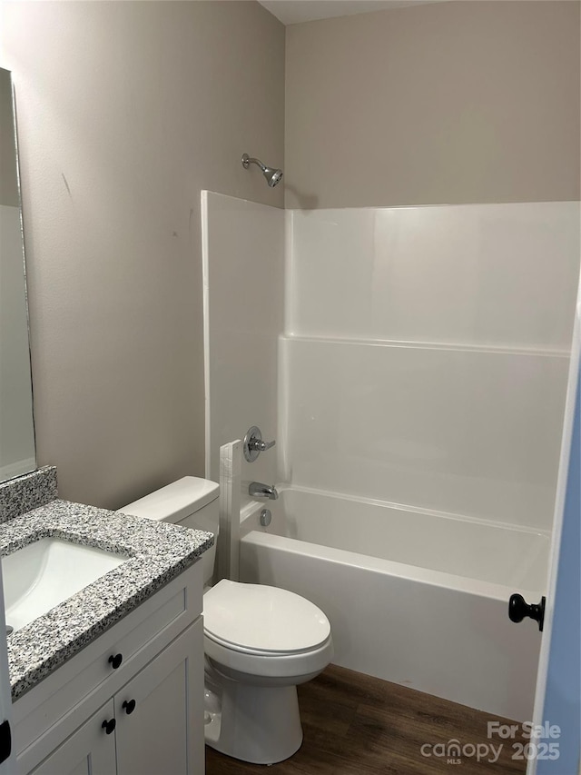 full bathroom with toilet, vanity, shower / bathing tub combination, and hardwood / wood-style flooring