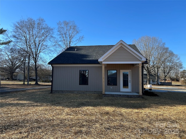 rear view of property with a yard