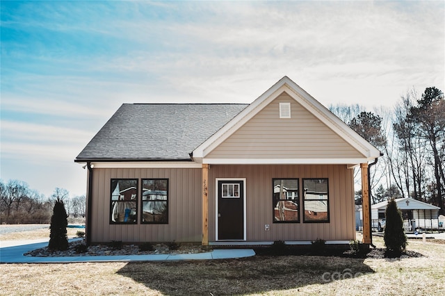 view of front of house with board and batten siding and roof with shingles