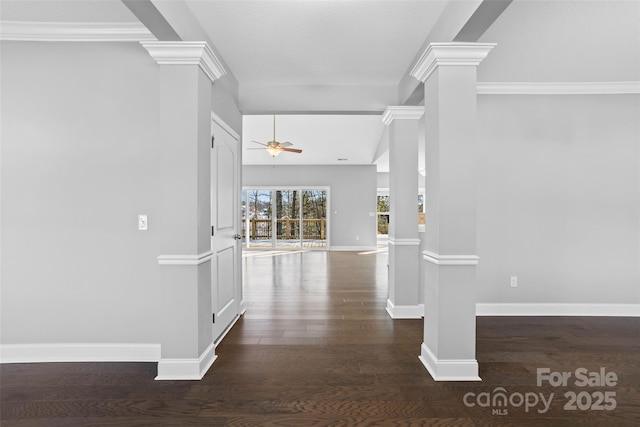 hall with dark wood-type flooring, crown molding, and ornate columns