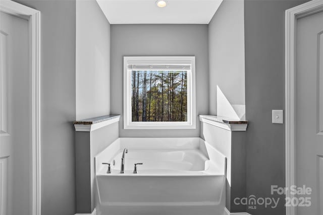 bathroom featuring a tub to relax in