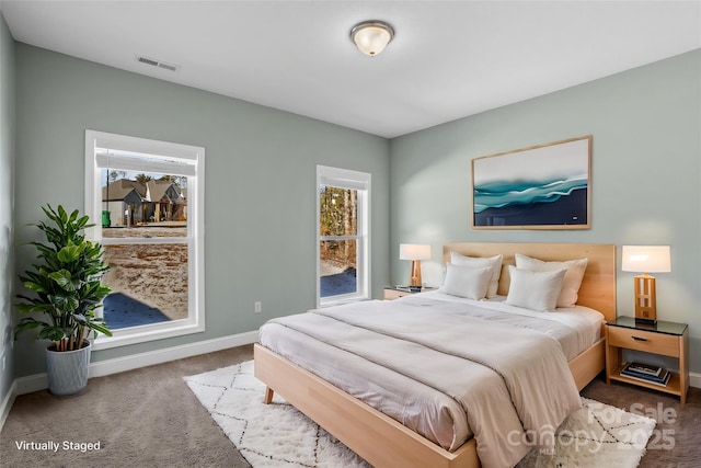 carpeted bedroom featuring multiple windows