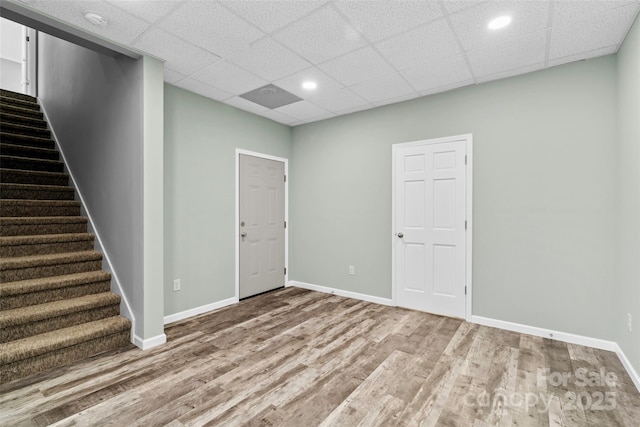 spare room featuring a paneled ceiling and hardwood / wood-style floors