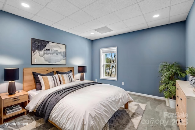 carpeted bedroom featuring a paneled ceiling