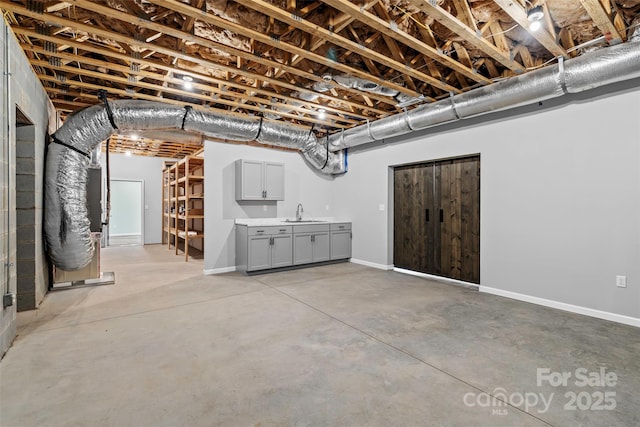 basement featuring heating unit and sink