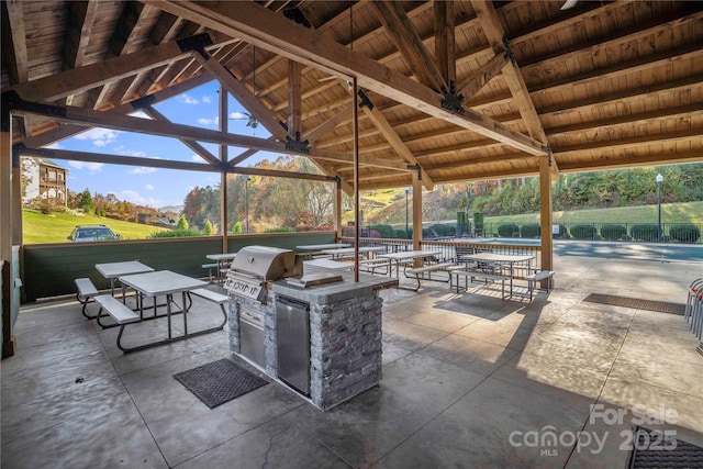 view of patio / terrace featuring a grill, an outdoor kitchen, and a gazebo