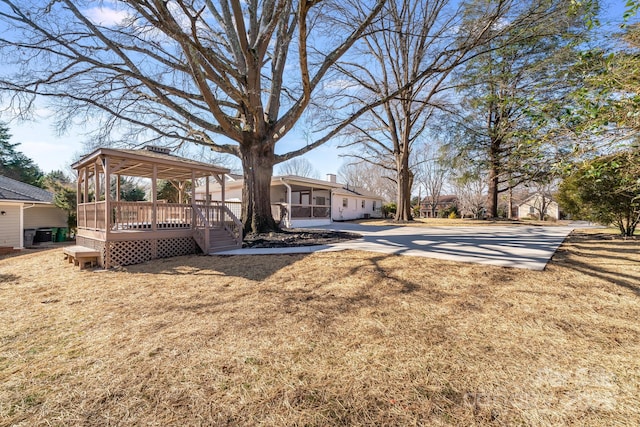 view of yard with a wooden deck and a gazebo