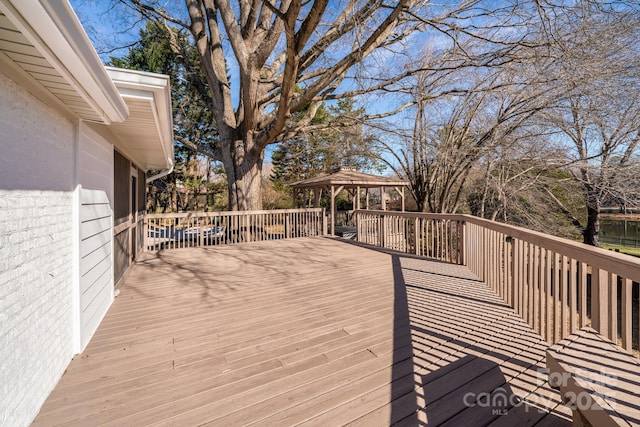 wooden deck featuring a gazebo and a water view