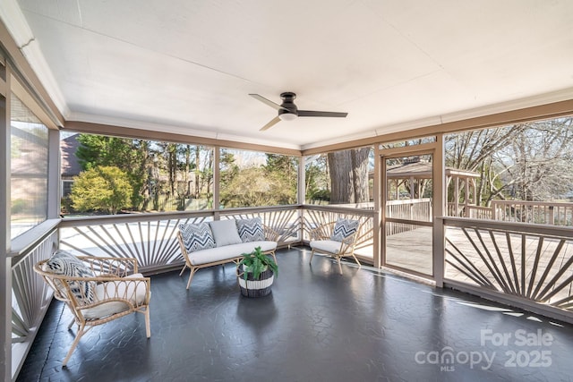 unfurnished sunroom featuring ceiling fan