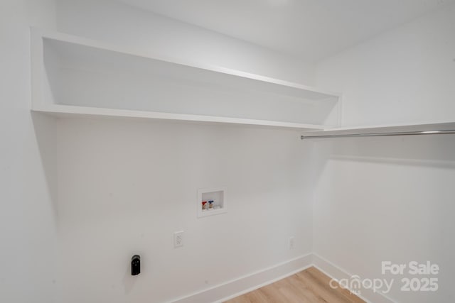 laundry room with wood-type flooring and hookup for a washing machine