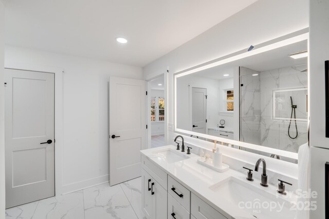 bathroom with vanity and a tile shower