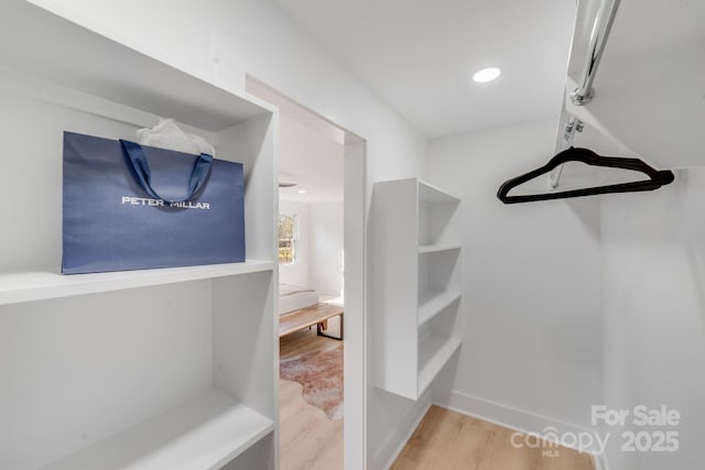 spacious closet featuring light hardwood / wood-style floors