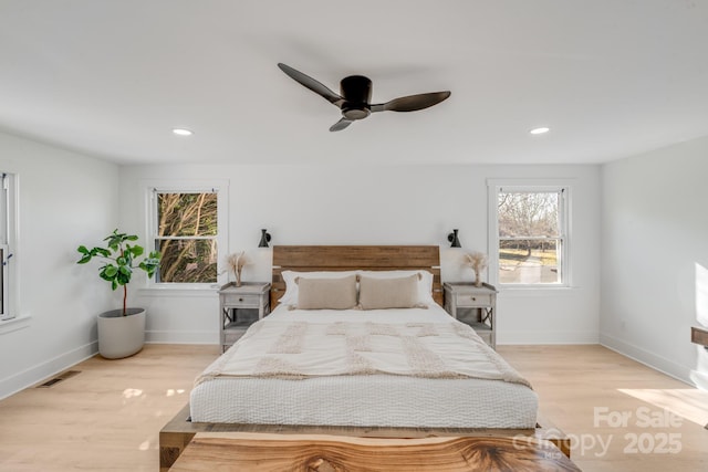 bedroom with ceiling fan and light hardwood / wood-style floors