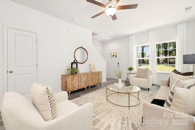 living room featuring hardwood / wood-style flooring and ceiling fan