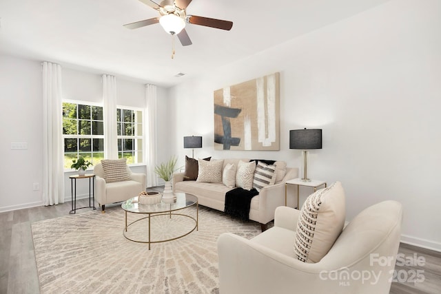 living room featuring ceiling fan and wood-type flooring