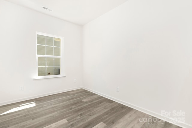 empty room with hardwood / wood-style floors