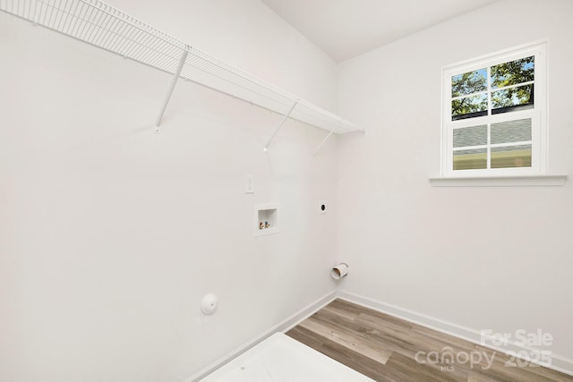 laundry area with hardwood / wood-style flooring, washer hookup, gas dryer hookup, and electric dryer hookup