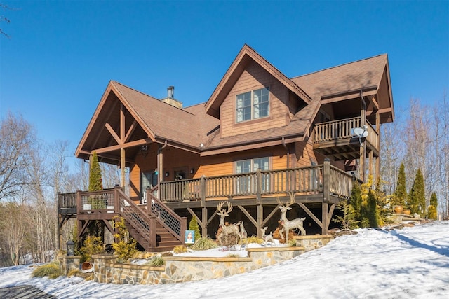 log-style house featuring a wooden deck