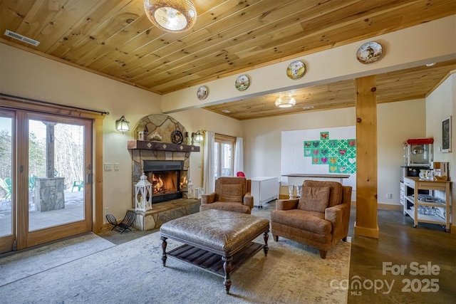 living room with wooden ceiling, plenty of natural light, and a stone fireplace