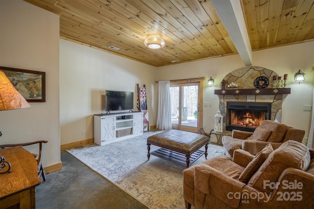 living room featuring wooden ceiling, concrete flooring, vaulted ceiling with beams, and a stone fireplace