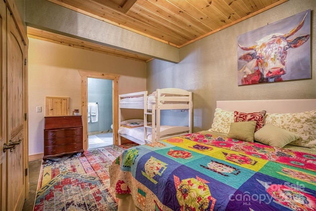 bedroom with carpet floors, ornamental molding, and wood ceiling