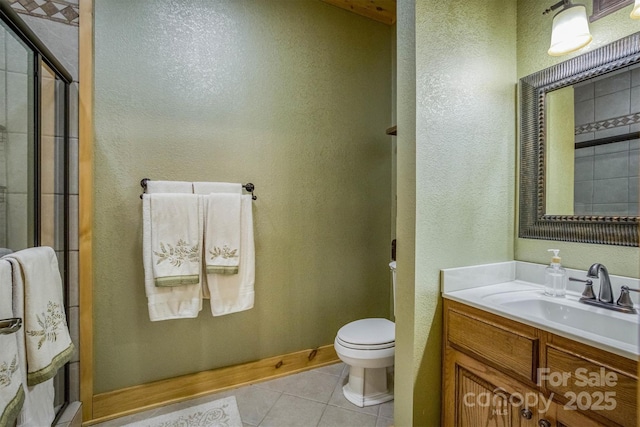 bathroom featuring toilet, tile patterned floors, an enclosed shower, and vanity