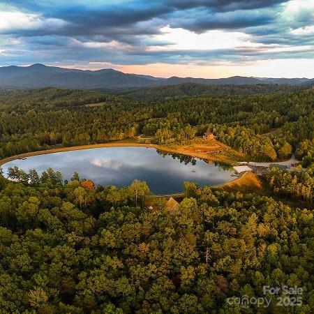 aerial view at dusk with a water and mountain view