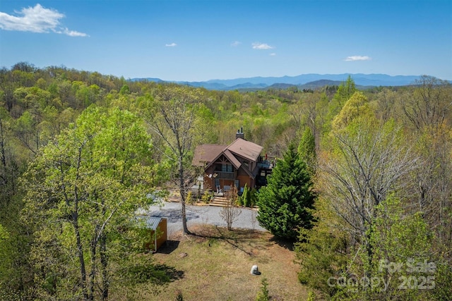 bird's eye view with a wooded view and a mountain view