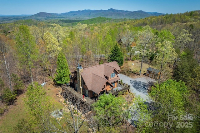drone / aerial view with a view of trees and a mountain view
