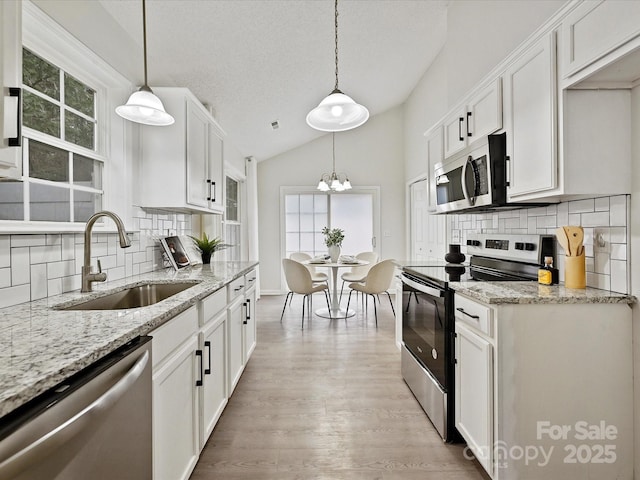 173 Brookshire Dr, Fort Mill, SC 29715 - kitchen featuring decorative light fixtures, appliances with stainless steel finishes, sink, and white cabinetry