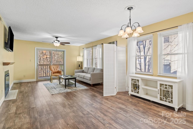 living room with a healthy amount of sunlight, hardwood / wood-style floors, and a textured ceiling