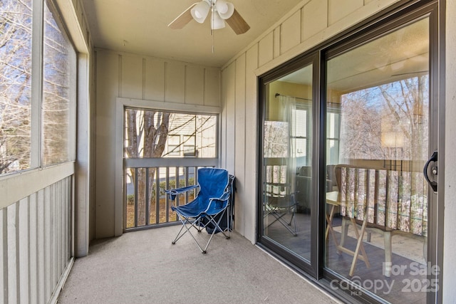 sunroom / solarium with plenty of natural light and ceiling fan