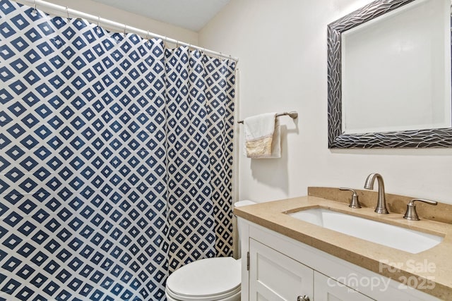 bathroom featuring walk in shower, vanity, and toilet