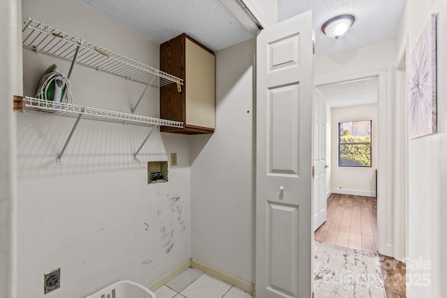 laundry area with washer hookup, light tile patterned floors, electric dryer hookup, and a textured ceiling