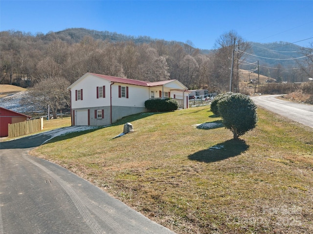 exterior space with a garage and a yard