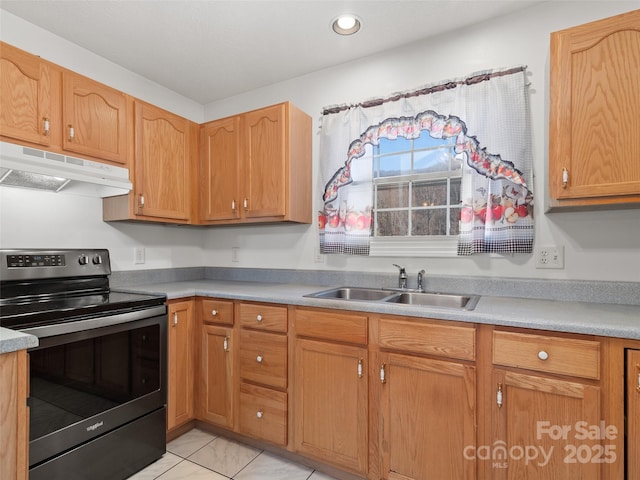 kitchen featuring light tile patterned floors, range with electric cooktop, and sink