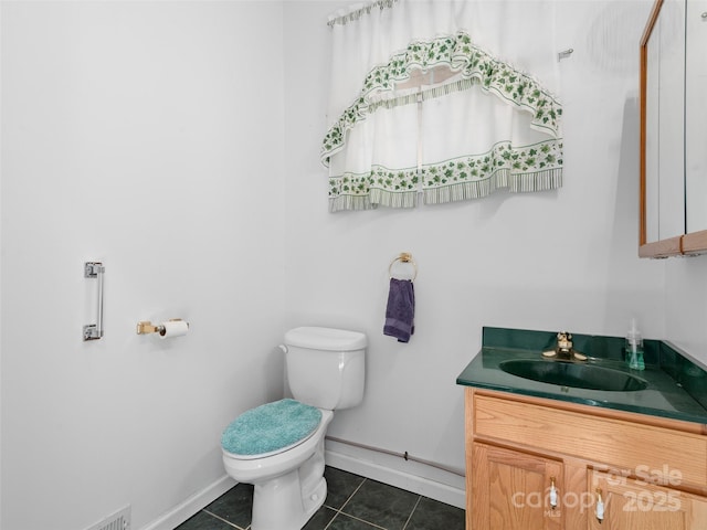 bathroom featuring toilet, vanity, and tile patterned floors