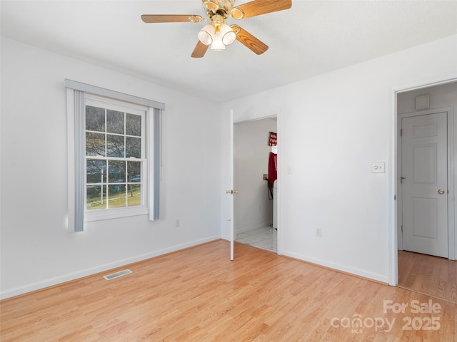 unfurnished room with ceiling fan and light hardwood / wood-style flooring