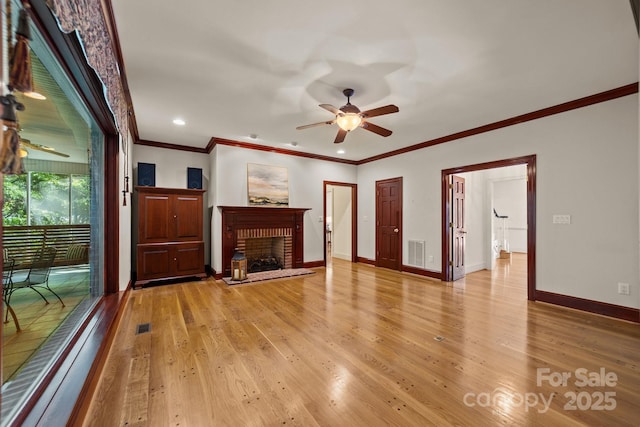 unfurnished living room featuring light hardwood / wood-style floors, a brick fireplace, and ceiling fan