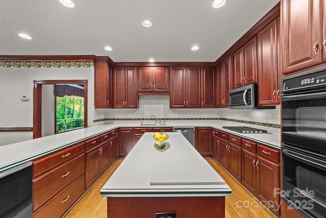 kitchen featuring a kitchen island, decorative backsplash, and appliances with stainless steel finishes