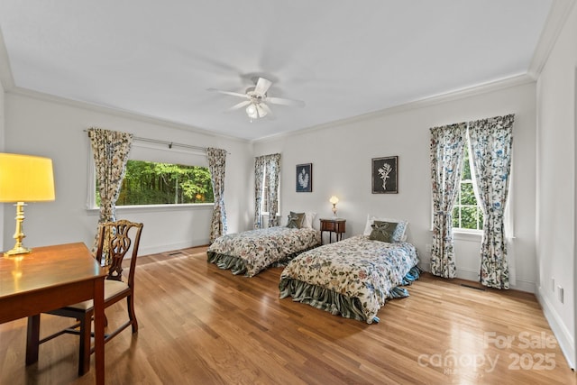 bedroom with ceiling fan, light hardwood / wood-style floors, and ornamental molding