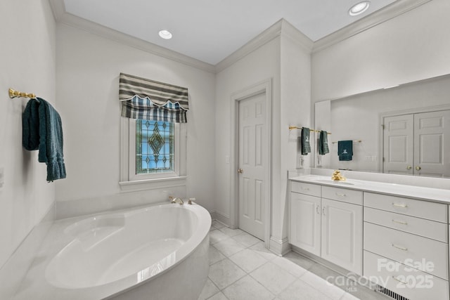 bathroom featuring a tub, ornamental molding, tile patterned flooring, and vanity