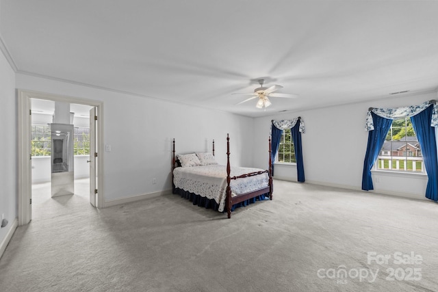 bedroom featuring ceiling fan, ornamental molding, light carpet, and multiple windows