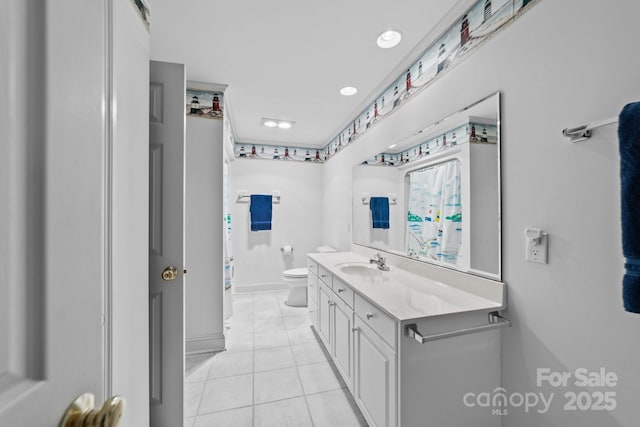 bathroom with toilet, tile patterned flooring, and vanity