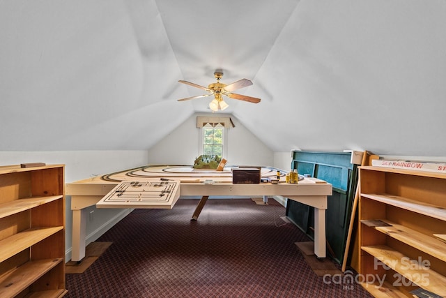 interior space featuring vaulted ceiling, carpet, and ceiling fan