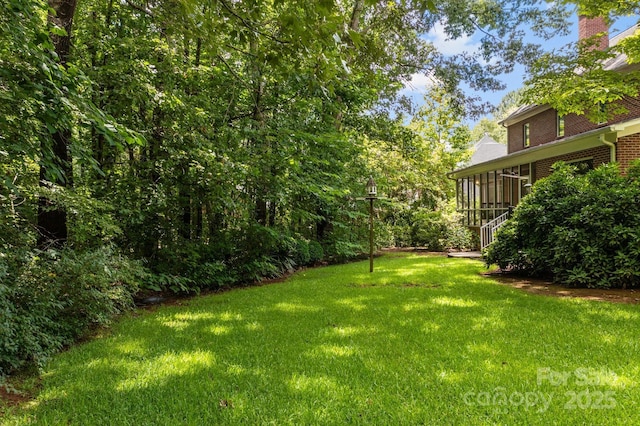 view of yard featuring a sunroom