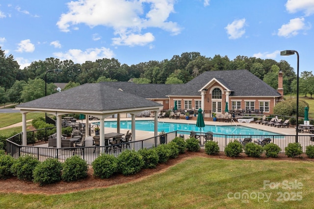 view of swimming pool with a lawn and a patio